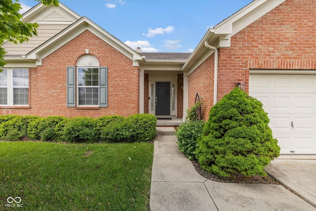 14018 Powder Dr, Carmel, IN 46033 - entrance to property featuring a garage, brick siding, and a yard