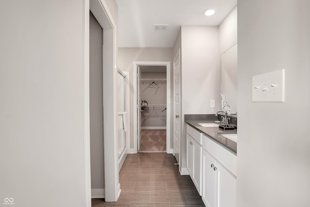1075 Marston Ln, Avon, IN 46123 - full bath featuring a walk in closet, vanity, baseboards, and a stall shower