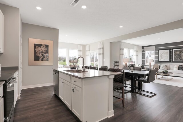 1075 Marston Ln, Avon, IN 46123 - kitchen with a sink, open floor plan, appliances with stainless steel finishes, a breakfast bar area, and dark wood-type flooring