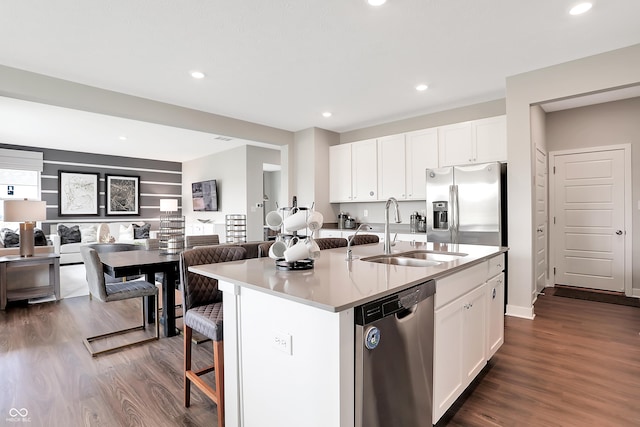 1075 Marston Ln, Avon, IN 46123 - kitchen featuring appliances with stainless steel finishes, a sink, dark wood-style floors, white cabinetry, and a kitchen island with sink