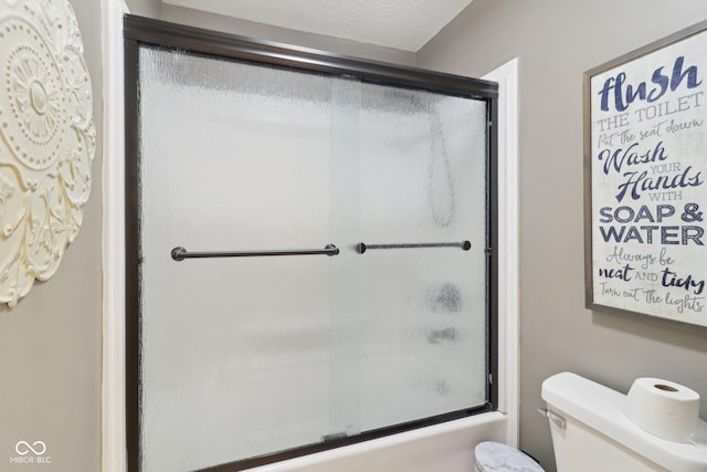 4732 Ferguson Rd, Indianapolis, IN 46239 - bathroom with toilet and bath / shower combo with glass door