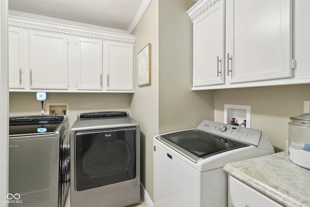 4732 Ferguson Rd, Indianapolis, IN 46239 - clothes washing area with washing machine and clothes dryer, cabinet space, and ornamental molding