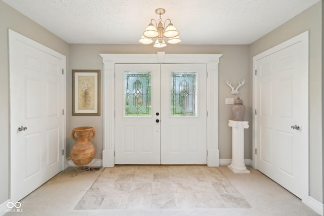 4732 Ferguson Rd, Indianapolis, IN 46239 - foyer featuring a chandelier, a textured ceiling, and baseboards