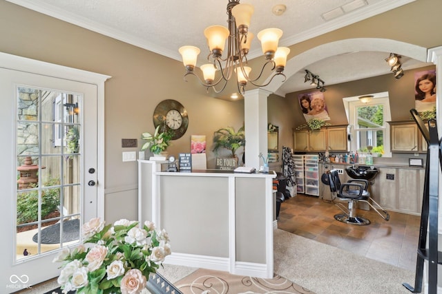 4732 Ferguson Rd, Indianapolis, IN 46239 - dining space featuring arched walkways, a chandelier, track lighting, ornamental molding, and a textured ceiling