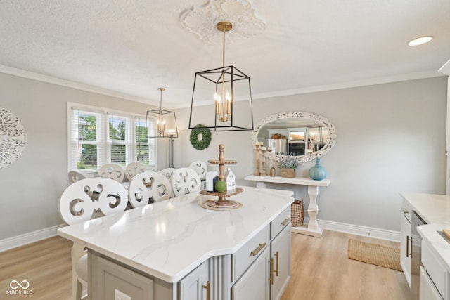 4732 Ferguson Rd, Indianapolis, IN 46239 - kitchen with light wood-type flooring, baseboards, a kitchen island, ornamental molding, and hanging light fixtures