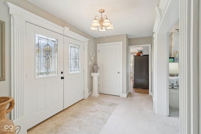 4732 Ferguson Rd, Indianapolis, IN 46239 - entryway with a chandelier, carpet, and a textured ceiling
