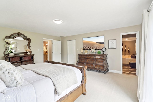 4732 Ferguson Rd, Indianapolis, IN 46239 - bedroom featuring light colored carpet, connected bathroom, baseboards, and a closet