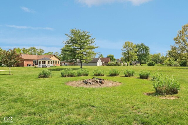 4732 Ferguson Rd, Indianapolis, IN 46239 - view of green lawn featuring an outdoor fire pit