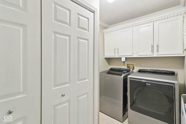 4732 Ferguson Rd, Indianapolis, IN 46239 - washroom with independent washer and dryer, cabinet space, ornamental molding, a textured ceiling, and light tile patterned floors