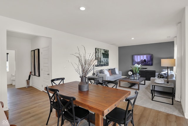 dining room with light wood-type flooring and recessed lighting
