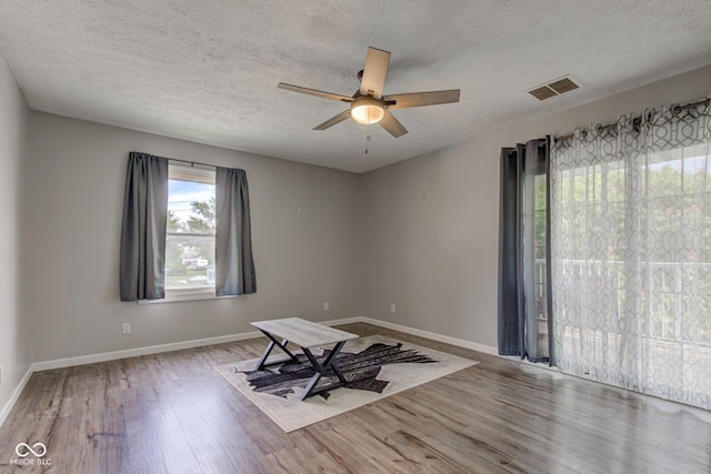 822 E King St, Kokomo, IN 46901 - spare room featuring wood finished floors, a ceiling fan, baseboards, and a textured ceiling