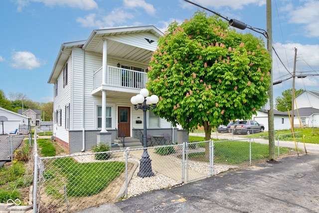 822 E King St, Kokomo, IN 46901 - view of front of property with a balcony, a gate, and a fenced front yard