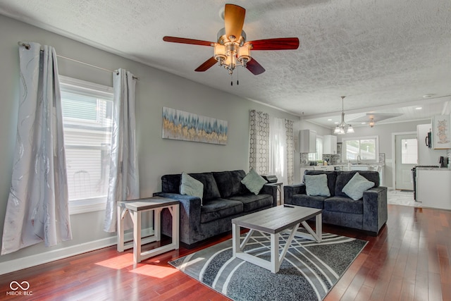 822 E King St, Kokomo, IN 46901 - living area featuring a textured ceiling, ceiling fan, healthy amount of natural light, and dark wood-style floors