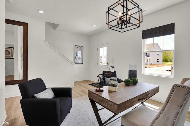 office featuring healthy amount of natural light, light wood finished floors, a chandelier, baseboards, and recessed lighting