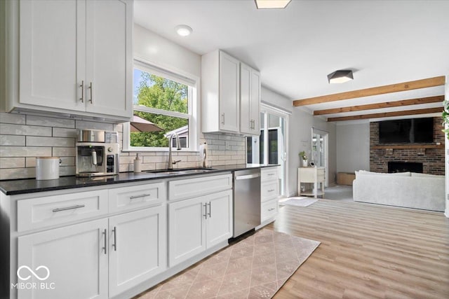 10444 Collingswood Ln, Fishers, IN 46037 - kitchen featuring dishwasher, a sink, beamed ceiling, tasteful backsplash, and a fireplace