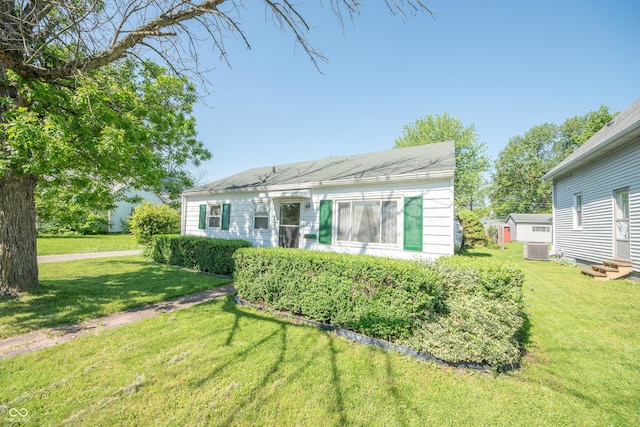 back of house with a lawn and central AC unit