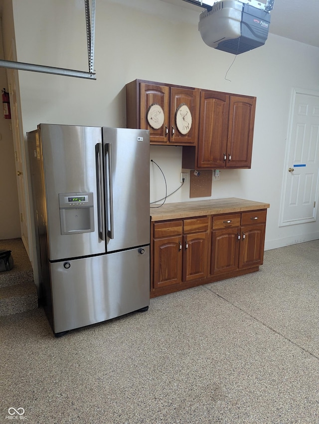 9640 Bramblewood Way, Carmel, IN 46032 - kitchen featuring stainless steel fridge with ice dispenser, light countertops, and brown cabinets