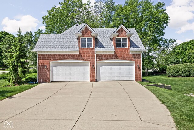 4956 Waterside Cir, Carmel, IN 46033 - view of front of home featuring a front yard, a garage, brick siding, roof with shingles, and concrete driveway
