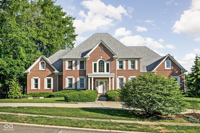 4956 Waterside Cir, Carmel, IN 46033 - colonial inspired home featuring brick siding, a front lawn, and roof with shingles