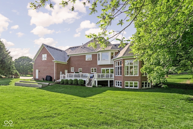 4956 Waterside Cir, Carmel, IN 46033 - rear view of house with brick siding, a yard, and a wooden deck