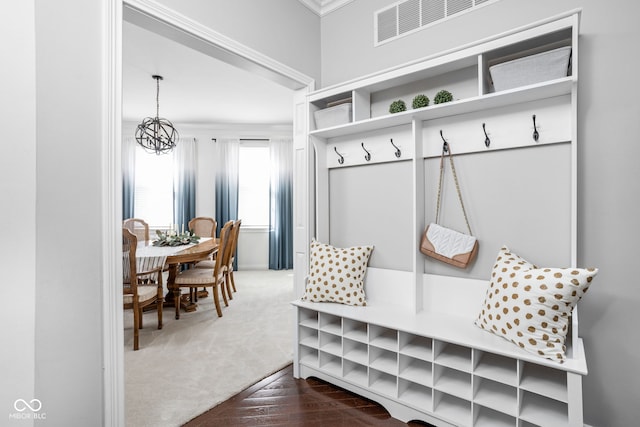 4956 Waterside Cir, Carmel, IN 46033 - mudroom featuring dark carpet, a chandelier, and crown molding