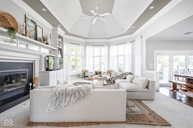 4956 Waterside Cir, Carmel, IN 46033 - living area with a fireplace with flush hearth, ornamental molding, ceiling fan, a tray ceiling, and recessed lighting