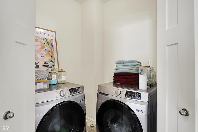 49 Manchester Dr, Trafalgar, IN 46181 - laundry area featuring washer and clothes dryer, baseboards, and tile patterned flooring