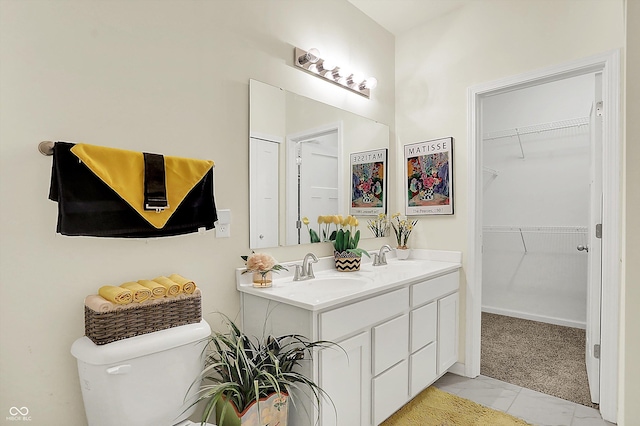 49 Manchester Dr, Trafalgar, IN 46181 - bathroom with double vanity, toilet, marble finish floors, and a spacious closet
