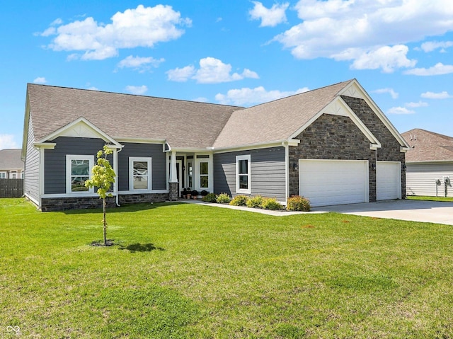 49 Manchester Dr, Trafalgar, IN 46181 - craftsman-style house with stone siding, an attached garage, concrete driveway, and a front yard