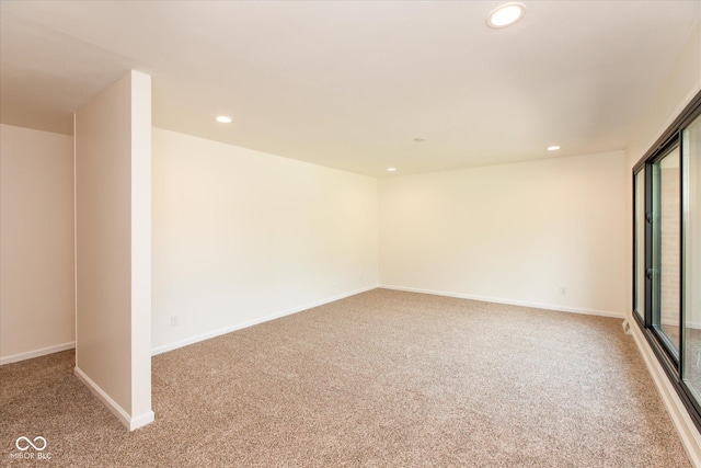 empty room with carpet floors, recessed lighting, and baseboards