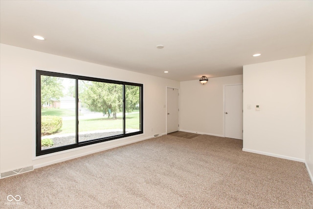 carpeted empty room with recessed lighting and baseboards