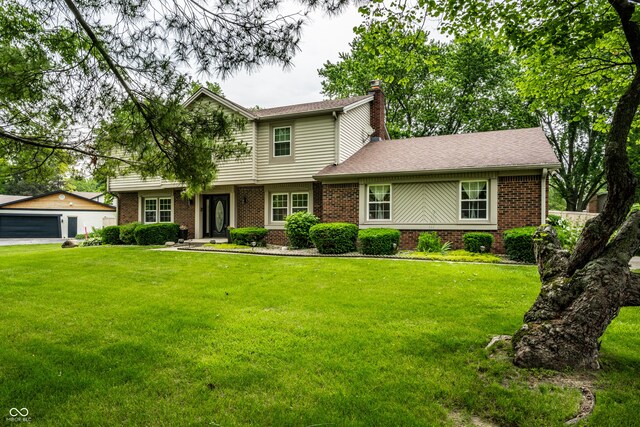 15203 Shoreway Ct, Carmel, IN 46032 - view of front of home with brick siding, a chimney, a front yard, and a garage