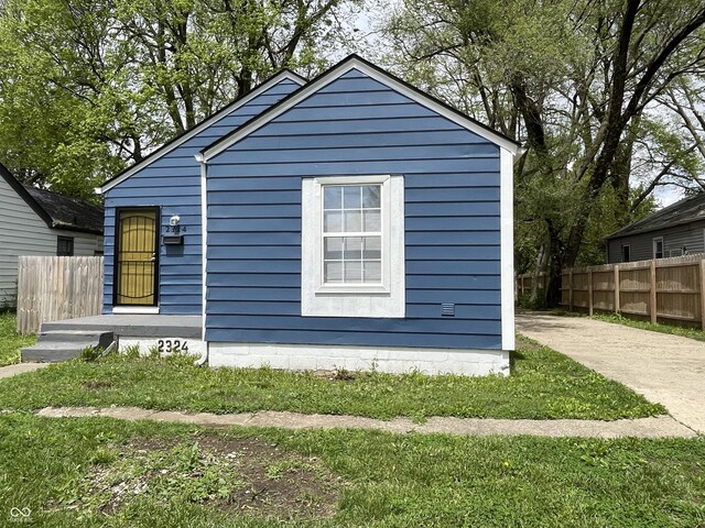 view of side of home featuring fence