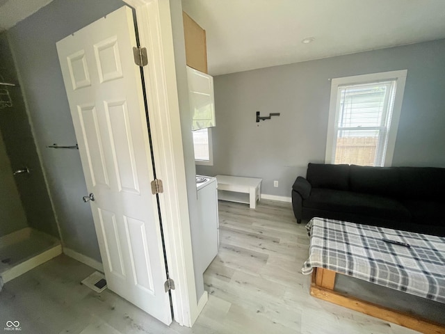 bedroom featuring baseboards and light wood-type flooring