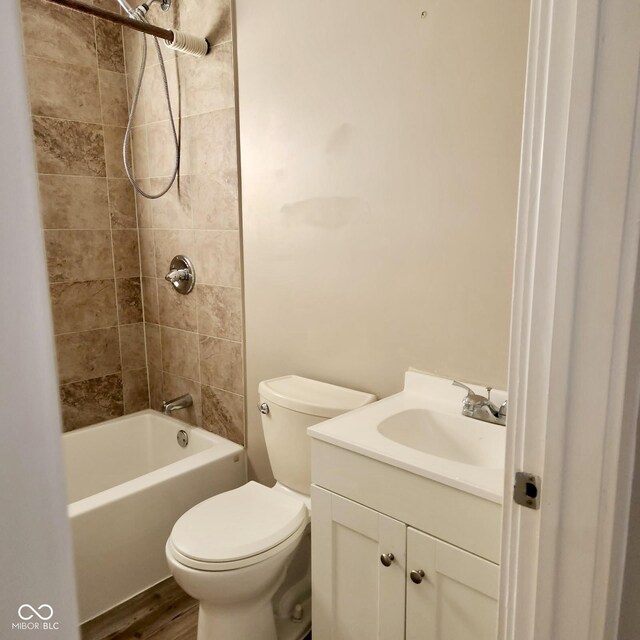 full bath featuring vanity, toilet, shower / washtub combination, and wood finished floors