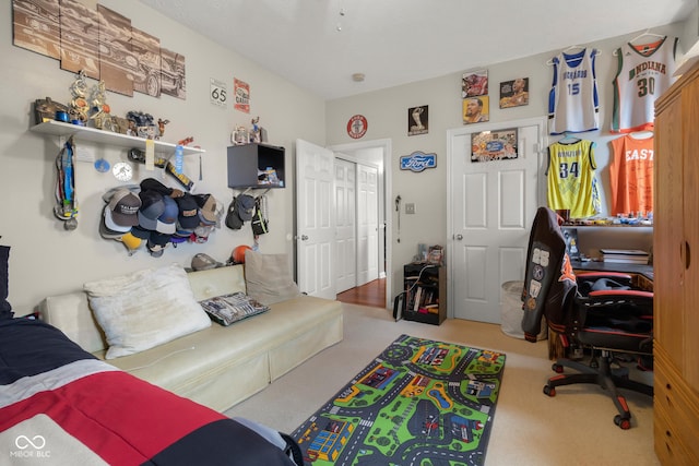 carpeted living area with a desk