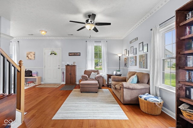 living room featuring a ceiling fan and wood finished floors