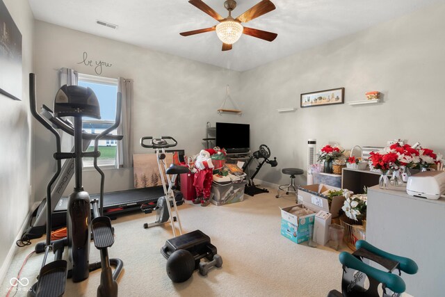 workout room with a ceiling fan, carpet flooring, and baseboards