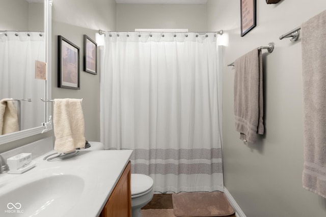 full bathroom featuring toilet, vanity, and a shower with shower curtain