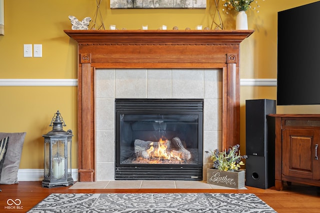 detailed view of wood finished floors and a fireplace