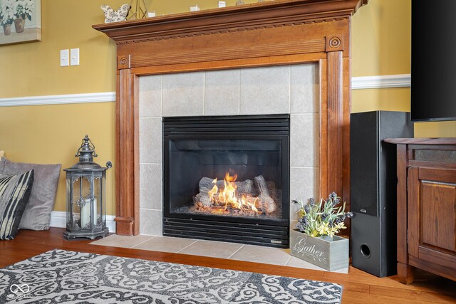 detailed view of a tiled fireplace and wood finished floors