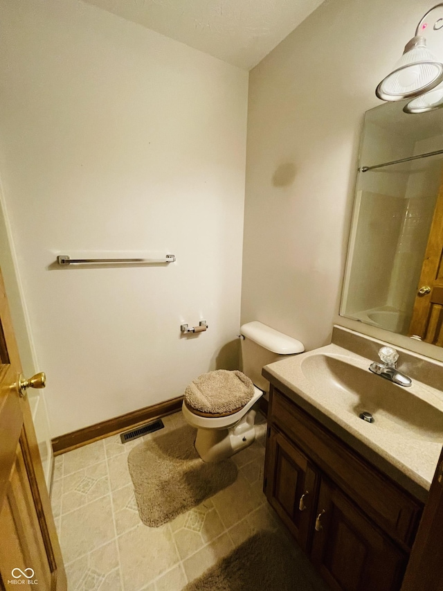 4706 W Old Trail Rd, Knightstown, IN 46148 - bathroom featuring vanity, toilet, and baseboards