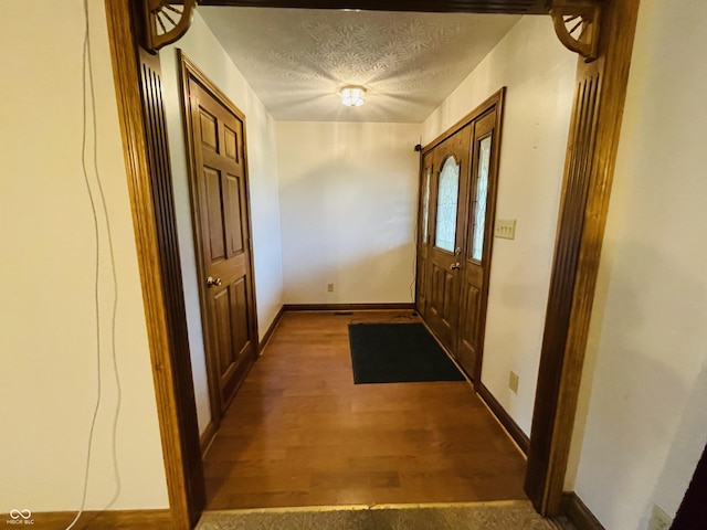 4706 W Old Trail Rd, Knightstown, IN 46148 - entryway with wood finished floors, a textured ceiling, and baseboards