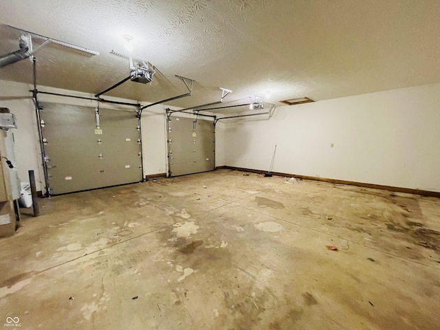4706 W Old Trail Rd, Knightstown, IN 46148 - garage featuring a garage door opener and baseboards