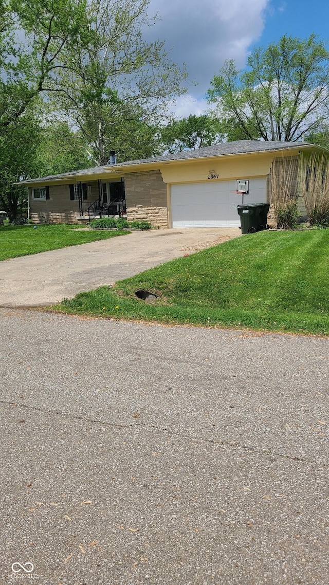 2867 S Oakland Dr, Shelbyville, IN 46176 - ranch-style home with asphalt driveway, an attached garage, and a front lawn