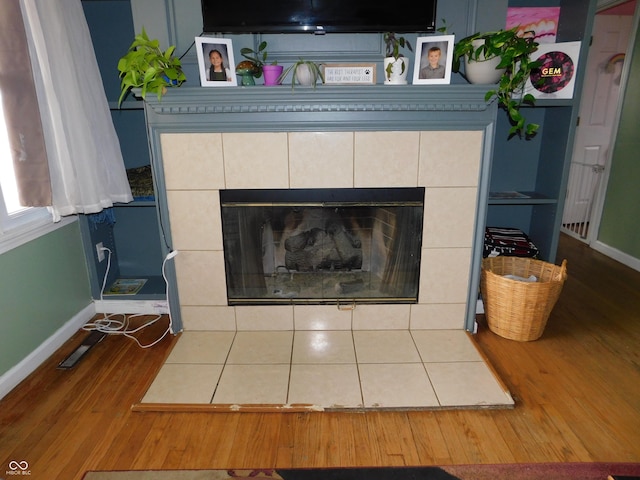2867 S Oakland Dr, Shelbyville, IN 46176 - detailed view of a tiled fireplace, baseboards, and wood finished floors