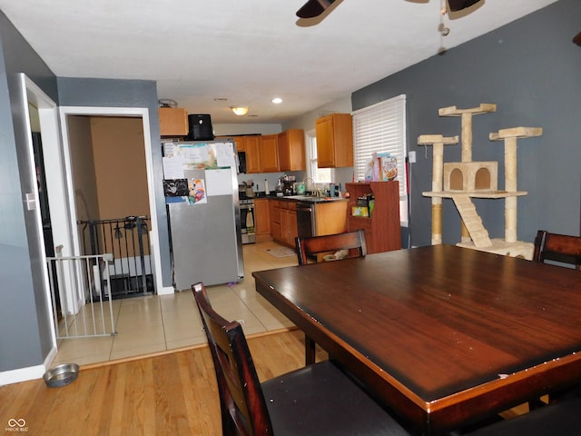 2867 S Oakland Dr, Shelbyville, IN 46176 - dining area with ceiling fan, light wood finished floors, and baseboards