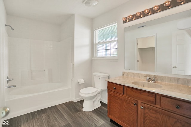 7156 Chemistry Ct, Indianapolis, IN 46239 - bathroom featuring wood finished floors, toilet, vanity, shower / tub combination, and baseboards