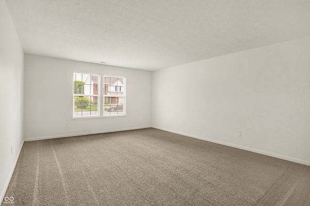7156 Chemistry Ct, Indianapolis, IN 46239 - empty room with carpet, baseboards, and a textured ceiling