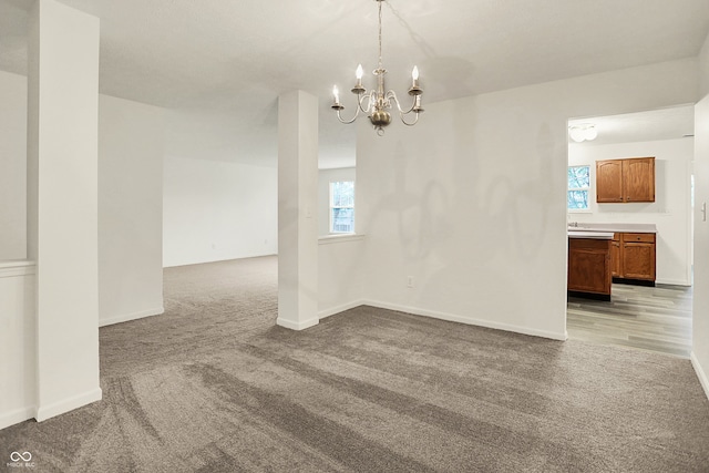 7156 Chemistry Ct, Indianapolis, IN 46239 - unfurnished dining area featuring light colored carpet, a chandelier, and baseboards